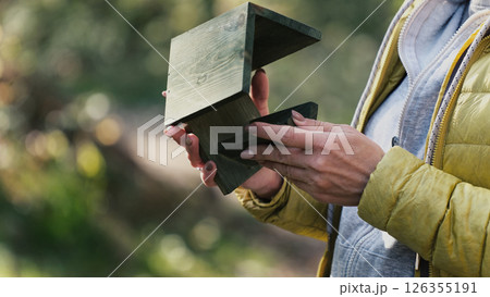 Girl Holding In Hands Wooden Birdhouse 126355191
