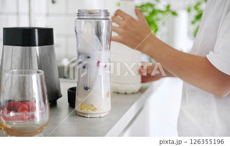 Little Girl Making A Milkshake And Shaking It With A Sport Shaker Little Girl Making A Milkshake And Shaking It With A Sport Shaker 126355196