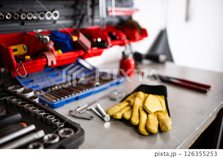Yellow Protective Gloves On A Mechanic Workbench Yellow Protective Gloves On A Mechanic Workbench 126355253