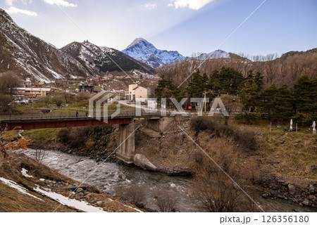 Terek river valley and Mount Kazbek, one of the highest peaks of Caucasus mountain range, in Stepantsminda in Georgia 126356180