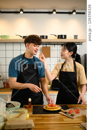 Young couple enjoying cooking together and creating a beautifully plated breakfast 126356326