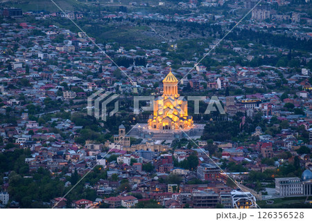 Night view of illuminated Holy Trinity Cathedral and the cityscape of Tbilisi, the capital of Georgia 126356528