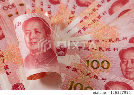 Roll of Chinese yuan 100 banknotes. Chinese paper currency Yuan renminbi banknotes as background. Close up. 126357950