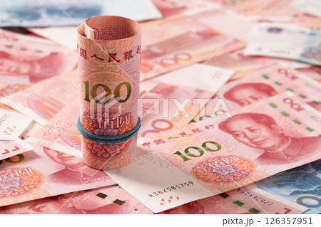 Roll of Chinese yuan 100 banknotes. Chinese paper currency Yuan renminbi banknotes as background. Close up. Roll of Chinese yuan 100 banknotes. Chinese paper currency Yuan renminbi banknotes as background. Close up. 126357951