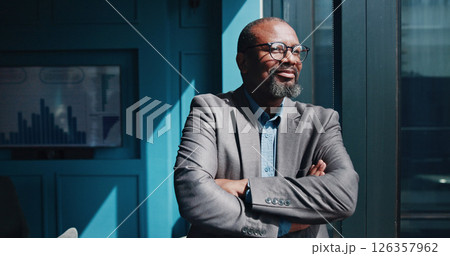 Thinking, employee and mature man with arms crossed, smile and ideas for financial growth in office. Confident, entrepreneur and black person with ambition for business, vision and contemplating 126357962