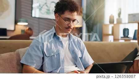 Remote work, man and laptop on sofa for research, email draft or creative writing in home. Freelance writer, tech or connectivity in living room for article editing, proofreading story or publication Remote work, man and laptop on sofa for research, email draft or creative writing in home. Freelance writer, tech or connectivity in living room for article editing, proofreading story or publication 126358007