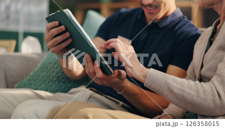 Caregiver, tablet and old woman on couch with hands, advice and medical consultation in senior care. Conversation, homecare and elderly person on sofa with nurse, digital app and health insurance. 126358015