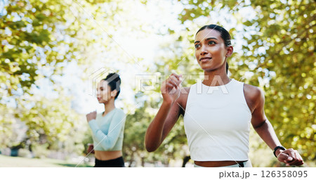 Women, fitness and workout in park with teamwork, exercise or support for endurance. Athlete, runner friends and running with marathon, training or development in nature for wellness and health goal 126358095