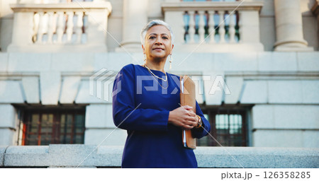 Lawyer, folder and portrait with business woman in city for court case files, trial assessment and attorney brief. Plead agreement, low angle and advocate paperwork with mature person outdoor 126358285