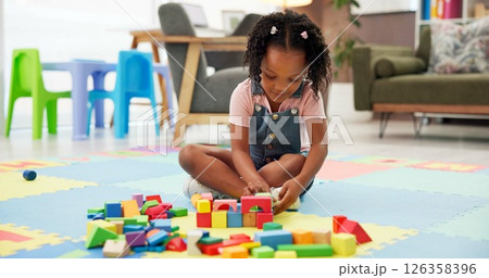 Kid, block and building with toys at office for fun activity, assessment or playing on floor. Black girl, child or student with shapes for playful learning, fine motor skills or elementary education Kid, block and building with toys at office for fun activity, assessment or playing on floor. Black girl, child or student with shapes for playful learning, fine motor skills or elementary education 126358396