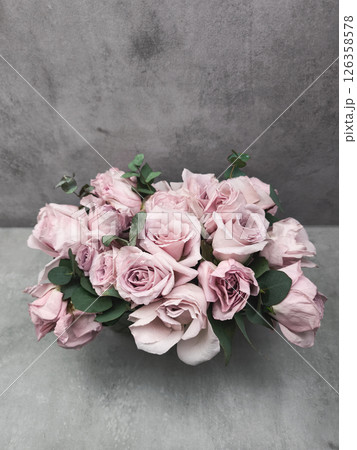Delicate pink roses forming an elegant bridal bouquet on a gray background wallpaper copy space 126358578