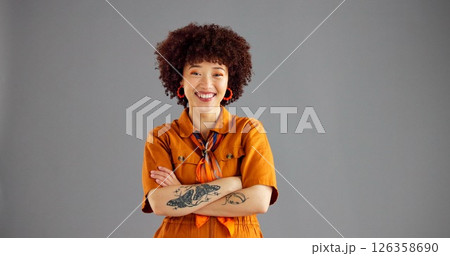 Portrait, smile and woman in studio, arms crossed and stylish clothes on grey background. Face, happy person and model with space, pride and positive mindset with casual outfit and fashion with gen z Portrait, smile and woman in studio, arms crossed and stylish clothes on grey background. Face, happy person and model with space, pride and positive mindset with casual outfit and fashion with gen z 126358690
