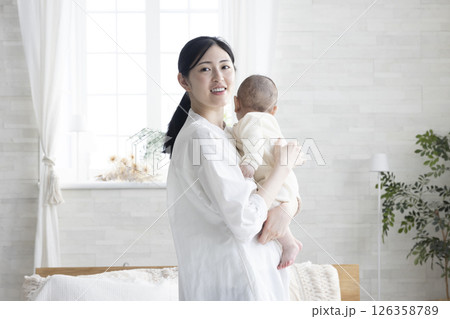 赤ちゃんを抱っこするお母さん 赤ちゃんを抱っこするお母さん 126358789