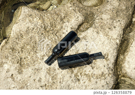 Two bottles of wine on the shore. Two bottles of wine on the shore. 126358879
