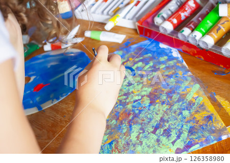 Close-up of a child hands smearing bright paints. Kids artistic creativity. 126358980