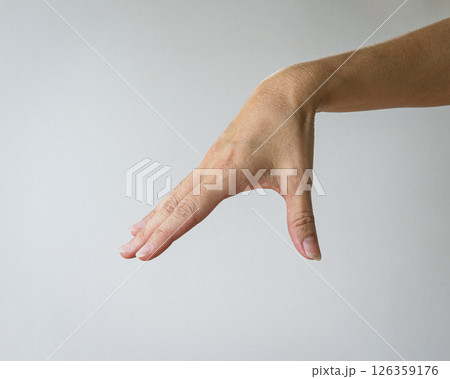Woman hand form a gesture of picking up something. Woman hand form a gesture of picking up something. 126359176
