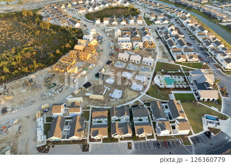 Wooden houses under construction in new developing suburban area. Development of residential housing in American suburbs. Real estate market in the USA 126360779