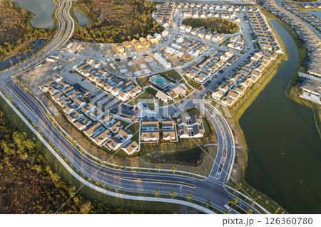Wooden frames of new cheap American homes under construction. Development of residential housing in the USA 126360780