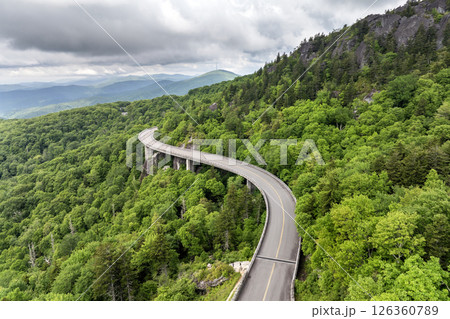 Winding mountain road in summer woods. Linn Cove Viaduct in Appalachian mountains in North Carolina with fresh green forest trees in summertime season. Beauty of USA nature 126360789