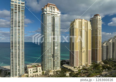 View from above of luxurious highrise hotels and condos on Atlantic ocean shore in Sunny Isles Beach city. American tourism infrastructure in southern Florida View from above of luxurious highrise hotels and condos on Atlantic ocean shore in Sunny Isles Beach city. American tourism infrastructure in southern Florida 126360816