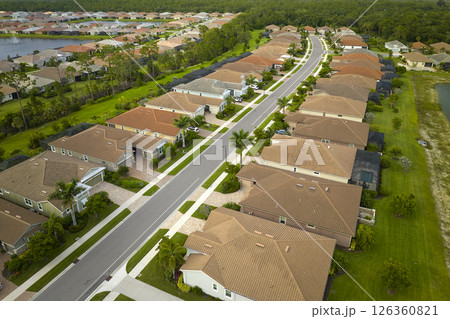 View from above of densely built residential houses in closed living clubs in south Florida. American dream homes as example of real estate development in US suburbs View from above of densely built residential houses in closed living clubs in south Florida. American dream homes as example of real estate development in US suburbs 126360821