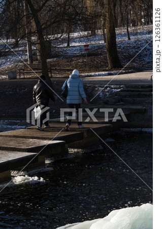 People cross a concrete bridge. People passing through the river 126361126