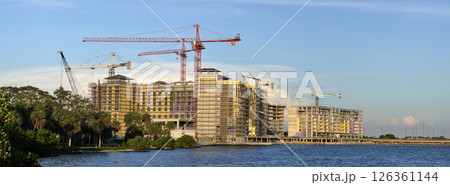 Tower cranes and frame structure of high residential apartment buildings at construction site. Real estate development Tower cranes and frame structure of high residential apartment buildings at construction site. Real estate development 126361144