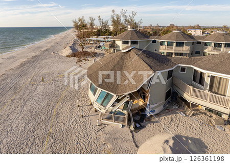 Storm surge severe damage to residential houses on ocean shore after hurricane landfall. Natural disaster consequences in Florida 126361198
