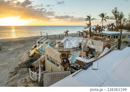 Storm surge severe damage to residential houses on ocean shore after hurricane landfall. Natural disaster consequences in Florida Storm surge severe damage to residential houses on ocean shore after hurricane landfall. Natural disaster consequences in Florida 126361199