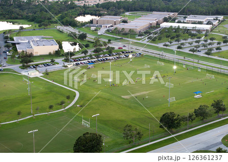 Schoolchildren playing football game on campus stadium in sports park 126361237