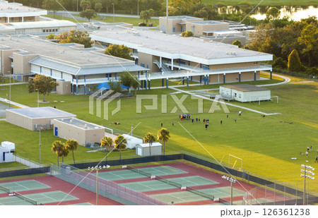 Schoolchildren playing American football game on campus stadium in sports park 126361238
