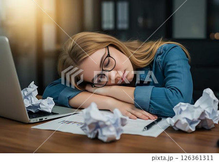 Tired Businesswoman Sleeping at Desk 126361311