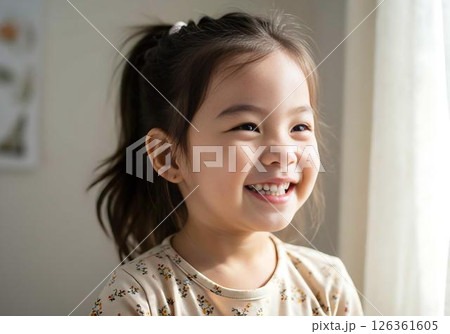 Happy Little Girl Smiling near Window 126361605