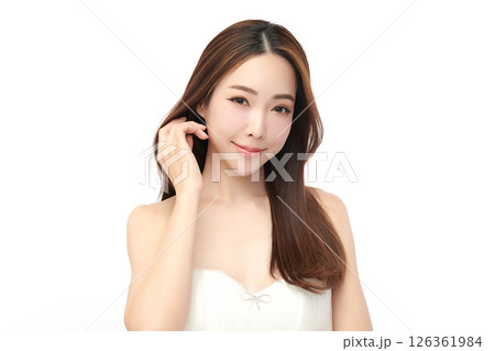 A beautiful young Asian woman with clean, fresh skin against a white background. Skincare, facial treatment, cosmetology, beauty, and spa. An elegant portrait of an Asian woman. A beautiful young Asian woman with clean, fresh skin against a white background. Skincare, facial treatment, cosmetology, beauty, and spa. An elegant portrait of an Asian woman. 126361984