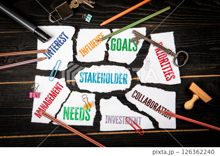 Stakeholder Management Concept with Torn Paper Keywords and Office Tools on Wooden Background 126362240