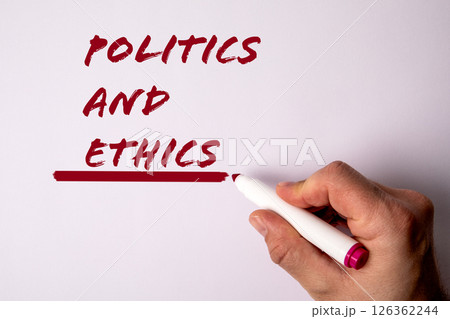 Politics and Ethics. Hand with Marker on White Background Politics and Ethics. Hand with Marker on White Background 126362244