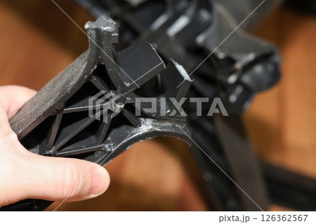 Man holding broken leg of office chair: workplace trouble, defective chair 126362567