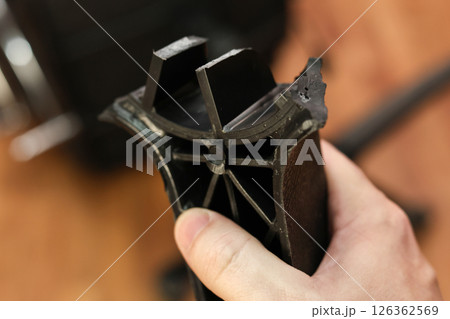 Man holding broken leg of office chair: workplace trouble, defective chair 126362569