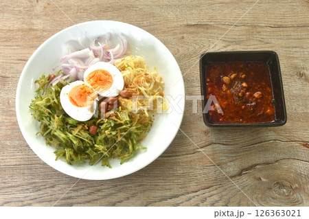 spicy and sour slice wing bean and banana blossom with chop pork sauce topping boiled egg Thai salad on plate 126363021