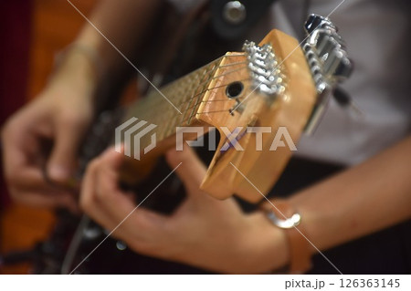 woman hand pushing cord and playing electric guitar woman hand pushing cord and playing electric guitar 126363145