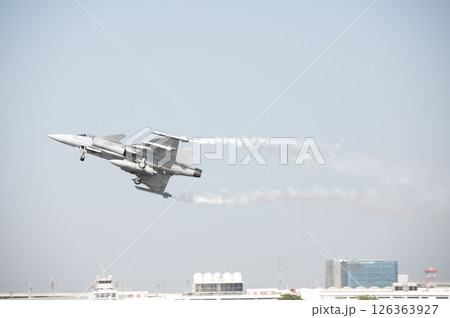 Fighter plane on blue sky background behind technology 126363927