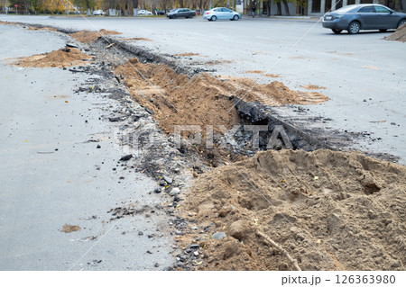 backfilling a trench with earth. construction work to replace a city water pipe 126363980