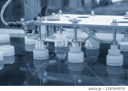 The material handling process the plastic bottle caps by automatic robotic system. 126364859