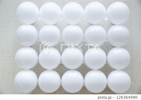 round white LED light bulb. many modern light bulbs on a white table round white LED light bulb. many modern light bulbs on a white table 126364990