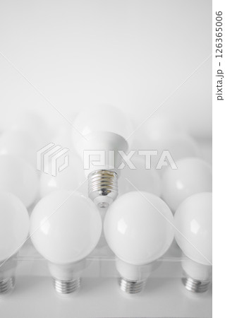round white LED light bulb. many modern light bulbs on a white table 126365006