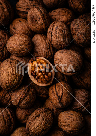 Pile of walnuts with one opened, showcasing texture Pile of walnuts with one opened, showcasing texture 126366467