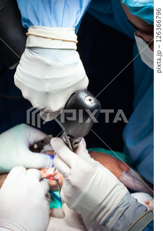 Female doctor performing a surgery. Orthopedic surgeon. Surgery and insurance concept. Female doctor performing a surgery. Orthopedic surgeon. Surgery and insurance concept. 126366796