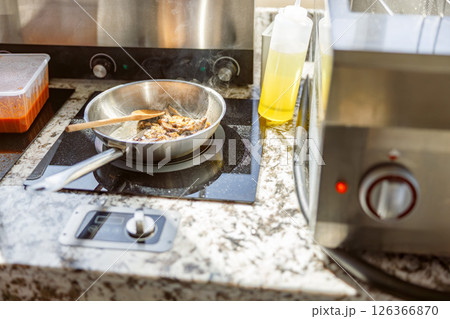 Cooking on a Modern Kitchen Countertop Using Fresh, Quality Ingredients for Delicious Meals Cooking on a Modern Kitchen Countertop Using Fresh, Quality Ingredients for Delicious Meals 126366870