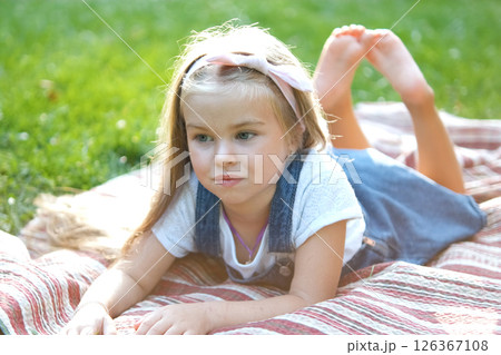 Portrait of pretty child girl resting outdoors in summer park. Portrait of pretty child girl resting outdoors in summer park. 126367108