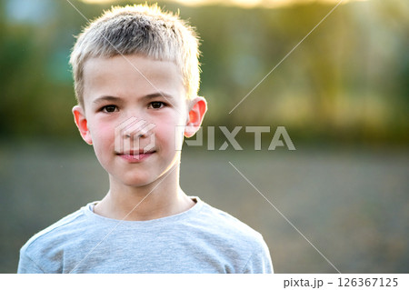 Portrait of a child boy outdoors on a warm sunny summer day. Portrait of a child boy outdoors on a warm sunny summer day. 126367125